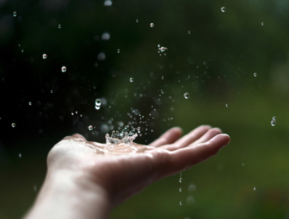 Image of raindrops falling on an open hand