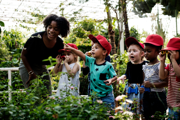 Image of a group of children pointing at flowers